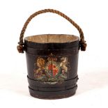 A slatted metal bound pail ebonised and decorated with the Royal Coat of Arms, with rope handle,