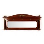 An Empire mahogany overmantel mirror with gilt metal mounts, the plate flanked by turned pilasters,