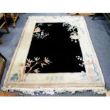 A Chinese washed rug with black central ground and white surround,