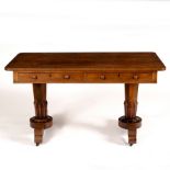 A William IV rosewood writing table with two short drawers, raised on octagonal taper end standards,