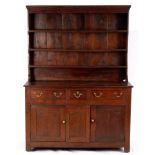 An early 18th Century style dresser, with shelves over and drawers and cupboard beneath,