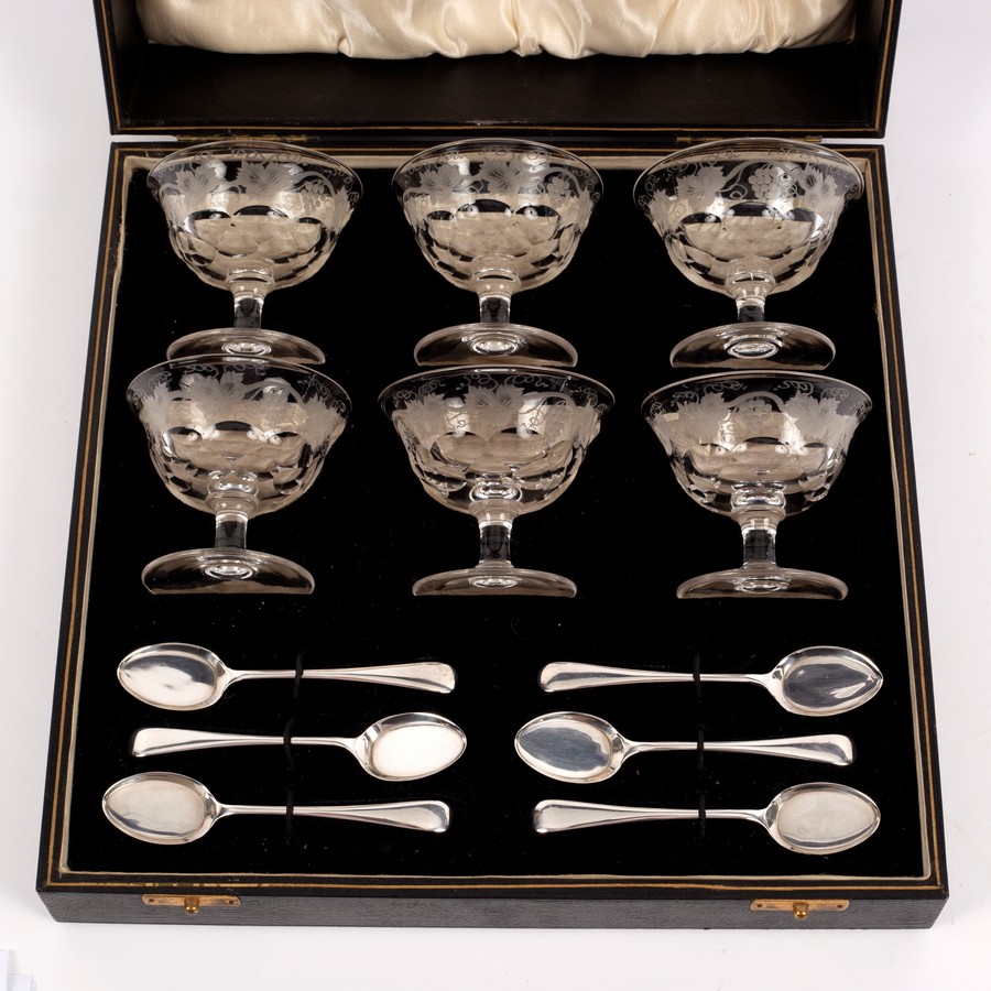 A cased set of six cut glass glacé dishes and six silver teaspoons,