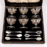 A cased set of six cut glass glacé dishes and six silver teaspoons,