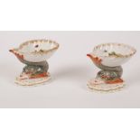 A pair of Berlin shell-shaped salts, circa 1900, with dolphin supports, 9.