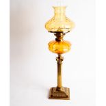 A 19th Century oil lamp with glass shade and well, on a Corinthian column candlestick base,