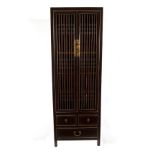 A Chinese black lacquer and gilded cabinet, the two slatted doors enclosing five shelves,