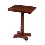 A Victorian rosewood table on an octagonal tapered column and quadruple support,