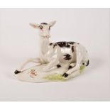 A Derby figure of a recumbent doe, circa 1758, enamelled with black and red patches,