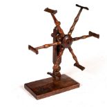 A fruitwood wool winder with spindle turned supports and square base,