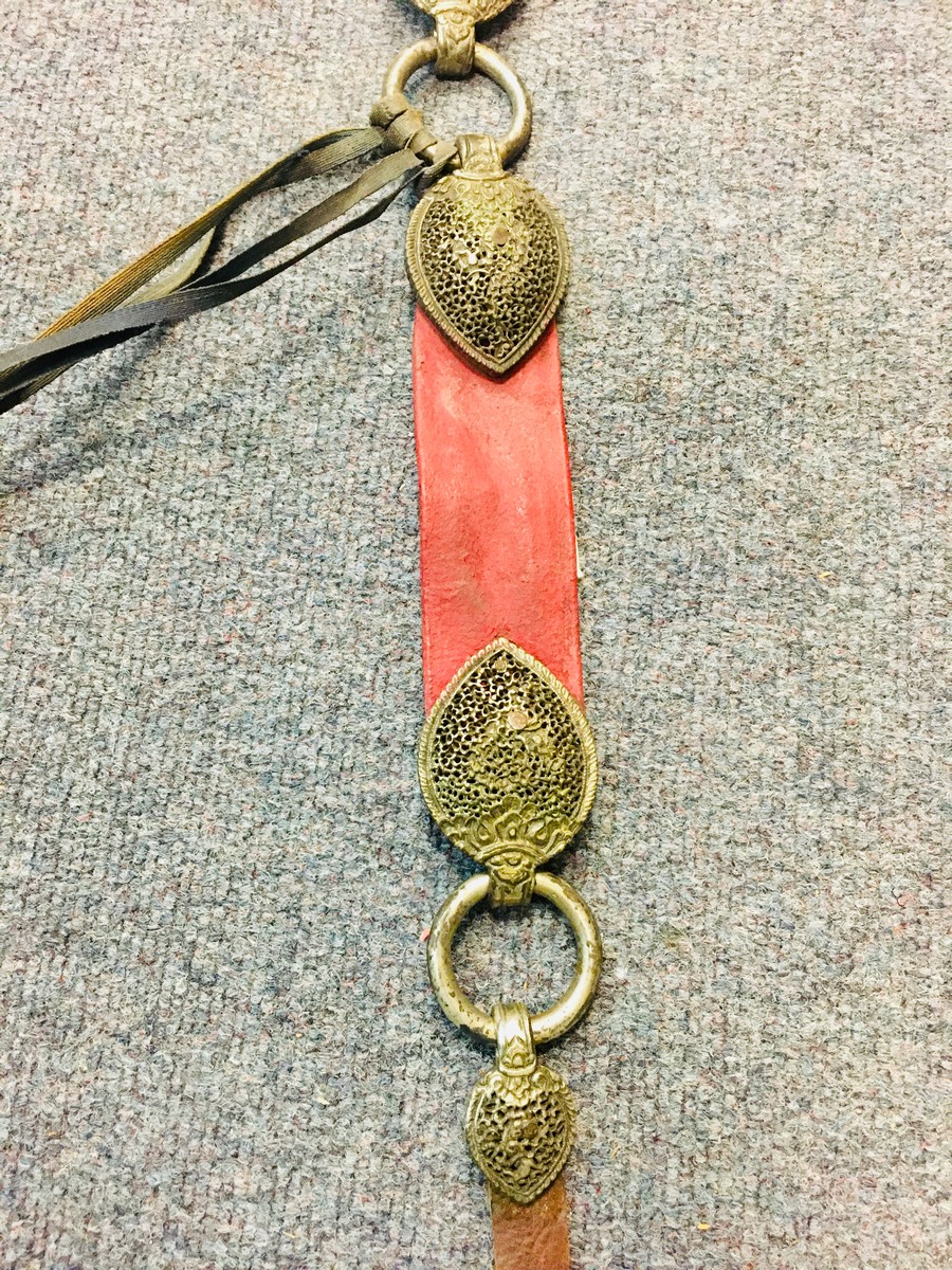 A Tibetan red leather horse strap with pierced silver coloured metal mounts, - Image 8 of 10