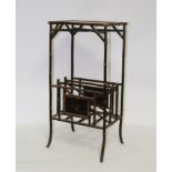 An Edwardian black lacquer and simulated bamboo magazine rack,