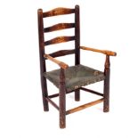 A child's ladder back chair with rush seat and turned legs