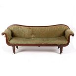 A Victorian mahogany double scroll end sofa raised on turned and reeded legs,