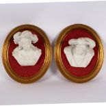 A pair of bisque porcelain wall busts, each depicting a figure in medieval dress,