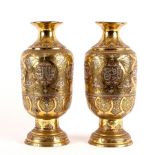 A pair of Eastern brass baluster vases,