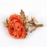 A coral brooch of flower form, set in an unhallmarked yellow metal frame, 7.
