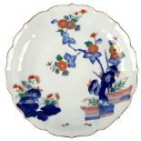 A Japanese Kakiemon fluted circular dish, seal mark,