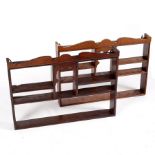 A pair of oak spice racks with moulded cornices, fitted shelves and an arch-top recess,