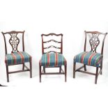 A pair of George III style mahogany single chairs with pierced upright splats to the backs and