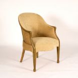 A tub armchair upholstered in pale green fabric with a painted wood frame