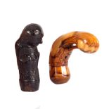 An ebonised kriss handle in the form of a grotesque and a vegetable ivory kriss handle carved
