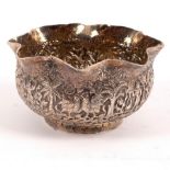 An Indian white metal sugar basin, profusely chased with figures and animals in a jungle landscape,