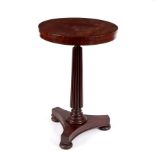 An early 19th Century rosewood table with reeded column and tripod support,