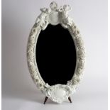 A Dresden porcelain white flower encrusted oval mirror frame, late 19th Century,