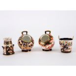 A group of Royal Crown Derby Imari miniatures comprising two coal scuttles and a churn,