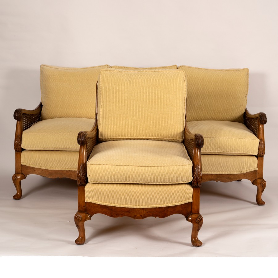 A bergère three-seater maple sofa and matching chair both upholstered in a rich cream flocked