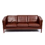 Stouby, Danish 1970s, a three-seater sofa of retro vintage design in mid-brown leather, 200cm wide,