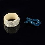 A white plastic hinged bracelet decorated crystals and a knot shaped brooch encrusted blue crystals
