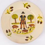 Adriano Martelo, a glazed pottery plate painted a farmer with pigs and acorns,