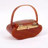 A 1940s bakelite handbag, casket shaped with gilt metal mounts,