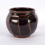 Nic Harrison (born 1949), a cut-sided stoneware vase of globular form covered in tenmoku glaze,