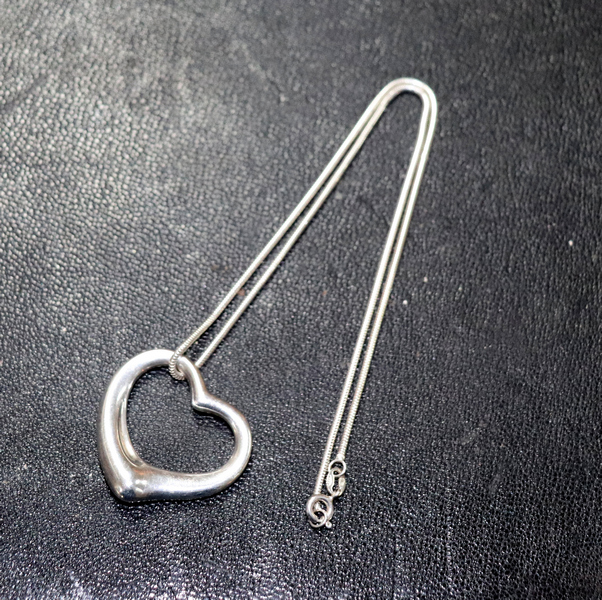 Elsa Peretti for Tiffany, a silver open heart pendant on Brazilian link chain, - Image 3 of 4