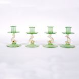 A set of four Venetian lustre glass candlesticks with dolphin supports,