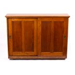 A Victorian Arts & Crafts oak stationery cupboard, with fitted interior, two sliding panel doors,