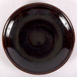 Edward Hughes (1953-2006), a large stoneware dish with slipware decoration under rim,