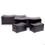 A pair of modern leather covered ottomans, with carry handles to the sides,