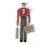 Butler & Wilson, a vintage style waterfall brooch in the form of a bellboy, the design with red,