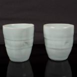 Edmund de Waal (born 1964), two porcelain beakers, 1995, pale celadon glaze with delicate crackle,