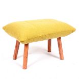 An upholstered stool by Habitat of yellow cushion form on four turned wood legs,