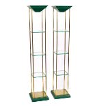 A pair of tall modern display stands, each with brass frame and three shelves,