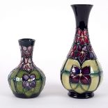 Moorcroft Pottery, two Violet pattern vases, design by Sally Tuffin, each of baluster form, 16.