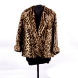 An ocelot fur jacket, with fold back cuffs and shawl collar,