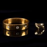 A French yellow gold hinged bangle set with three cushion shaped diamonds, approximately 33.