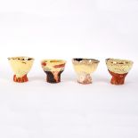Simon Carroll (1964-2009), four earthenware teabowls with coloured glazes,
