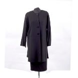 A Jean Muir black wool crepe suit, the half placket front jacket with round neck and side slits,