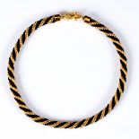 Celine, a black and gold twisted rope style necklace, the clasp stamped,